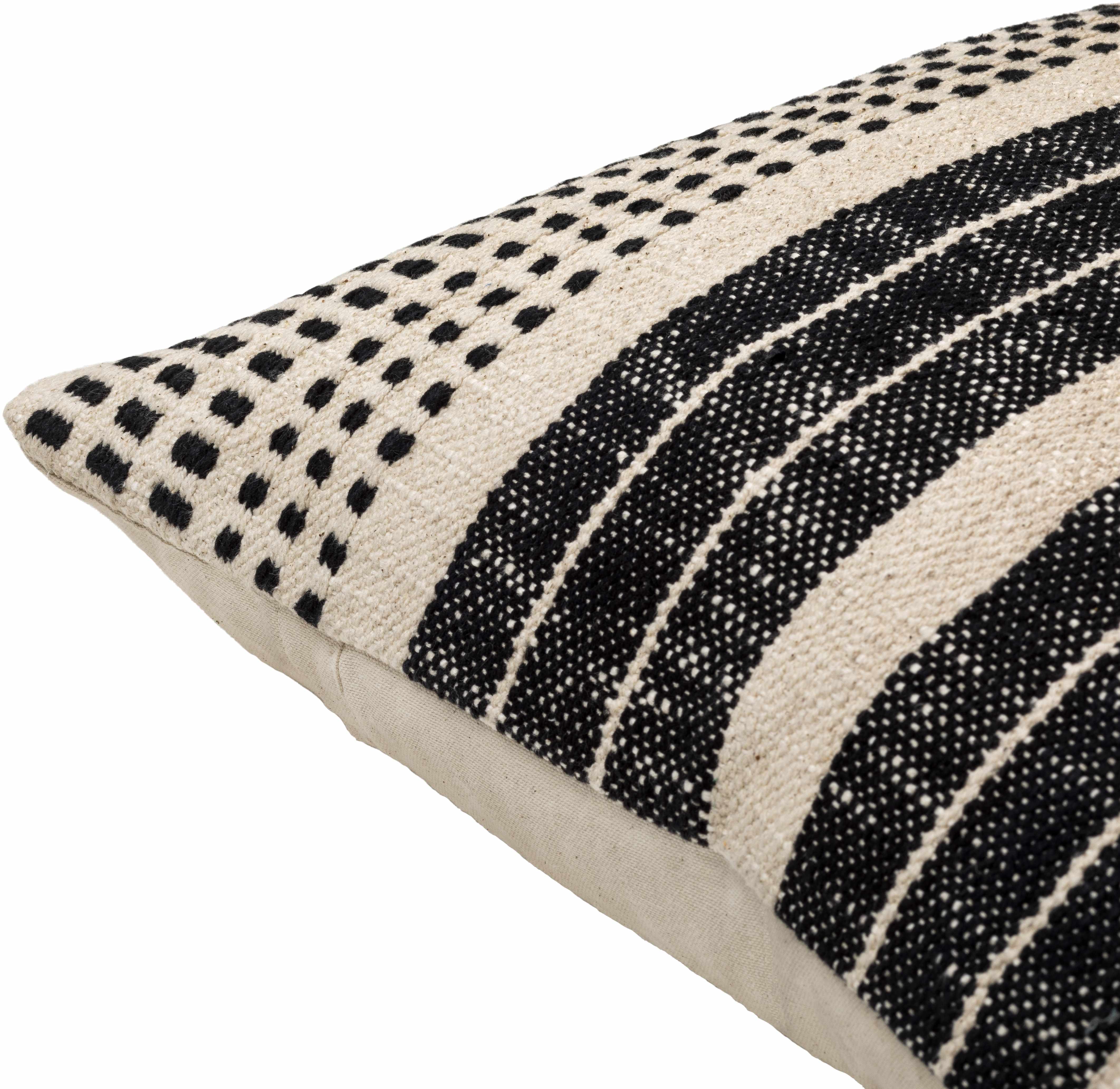 Decorative pillow with black and white pattern on a beige background