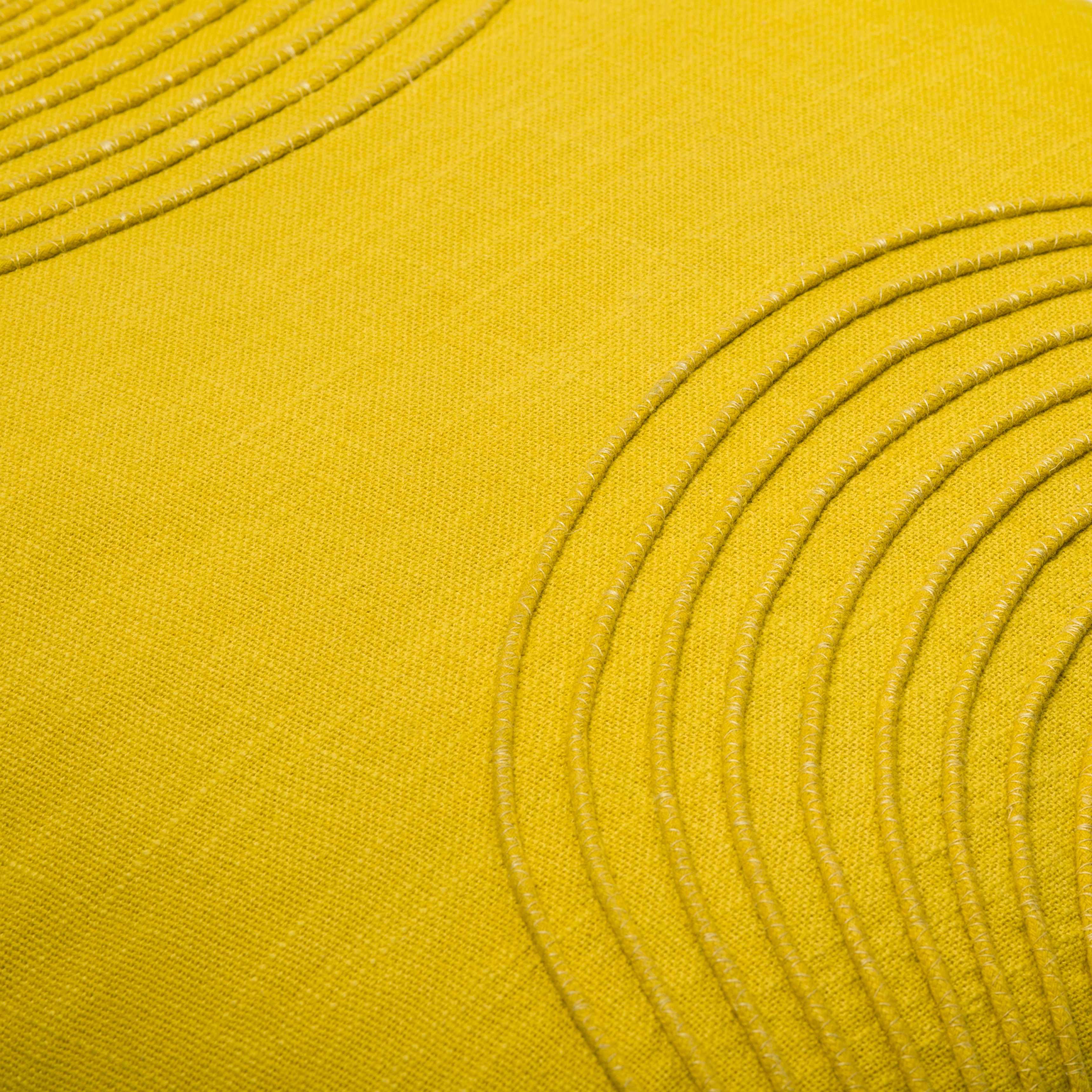 Close-up of yellow fabric with circular patterns