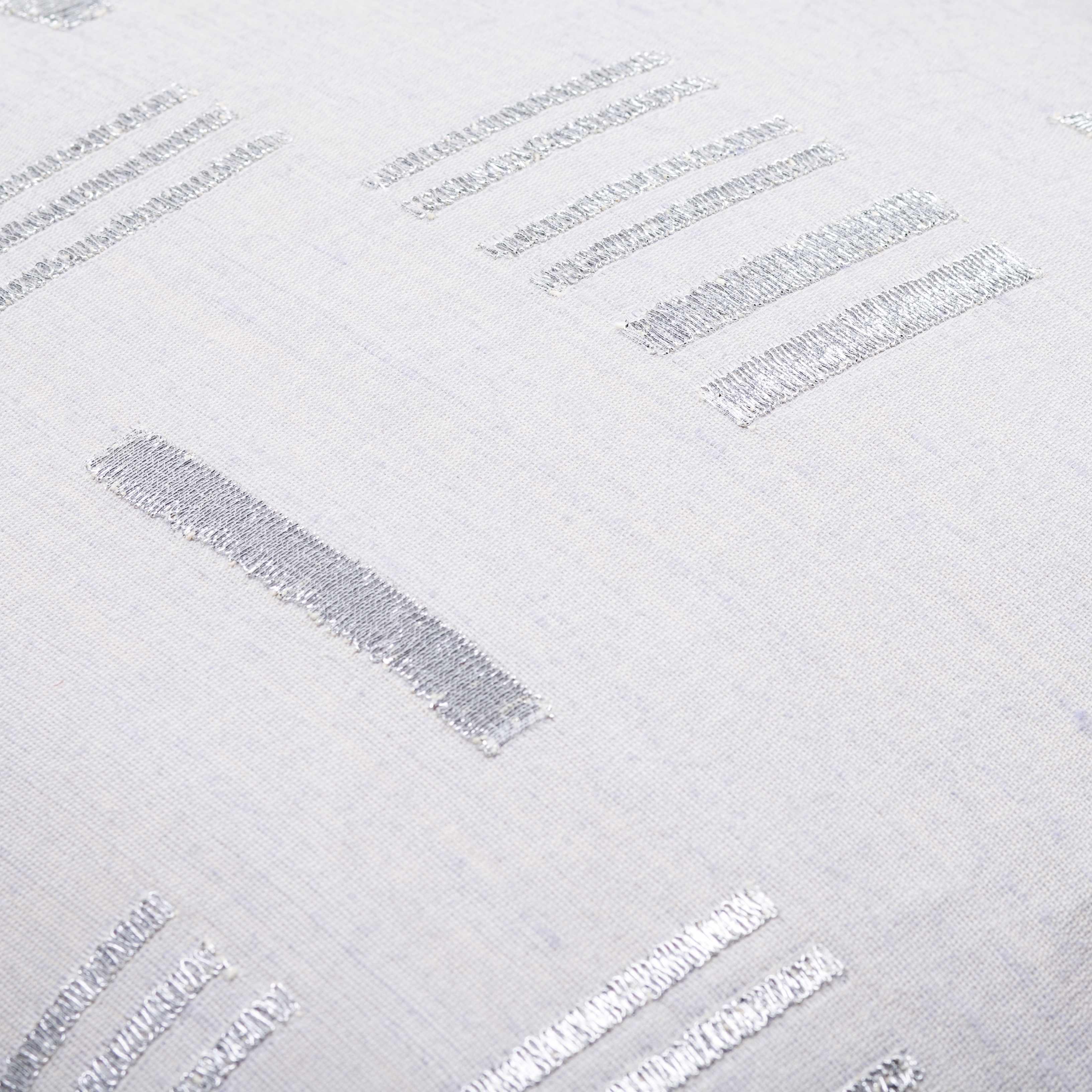 Close-up of a textured white surface with embossed text and patterns.