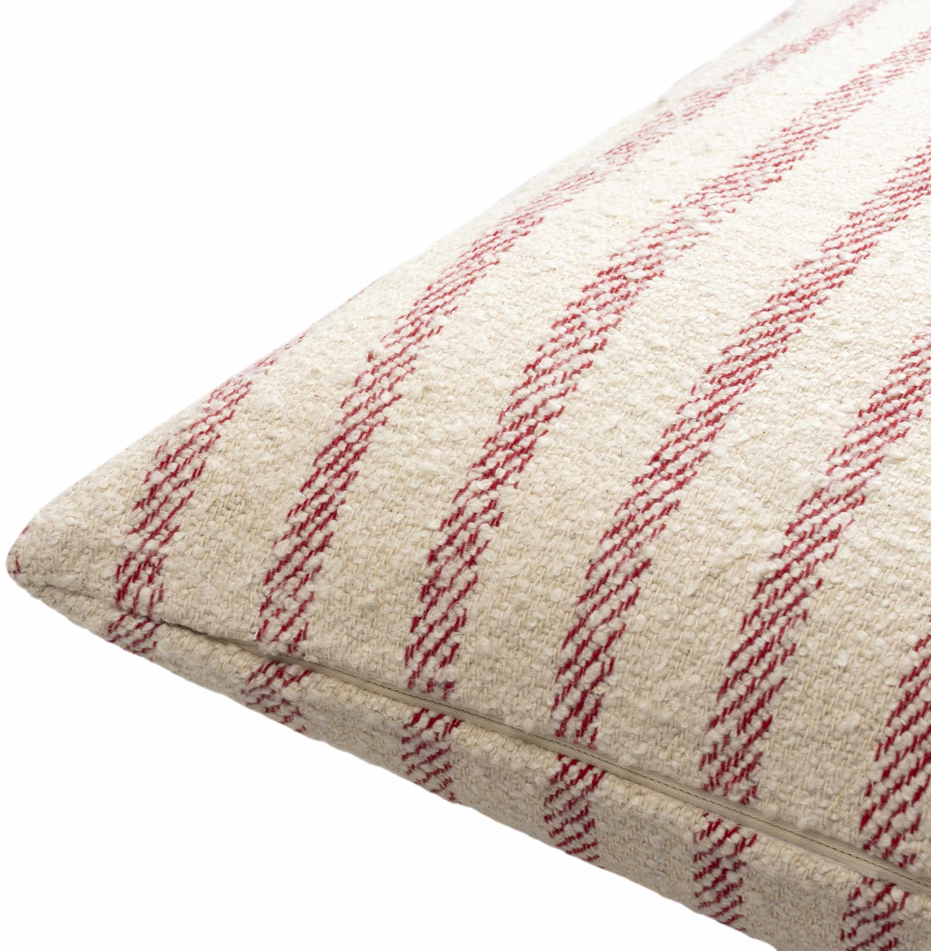 Textured pillow with red and beige stripes on a white background