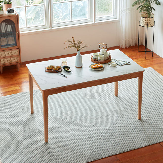 Wooden coffee table with a marble-like top in a living room setting.