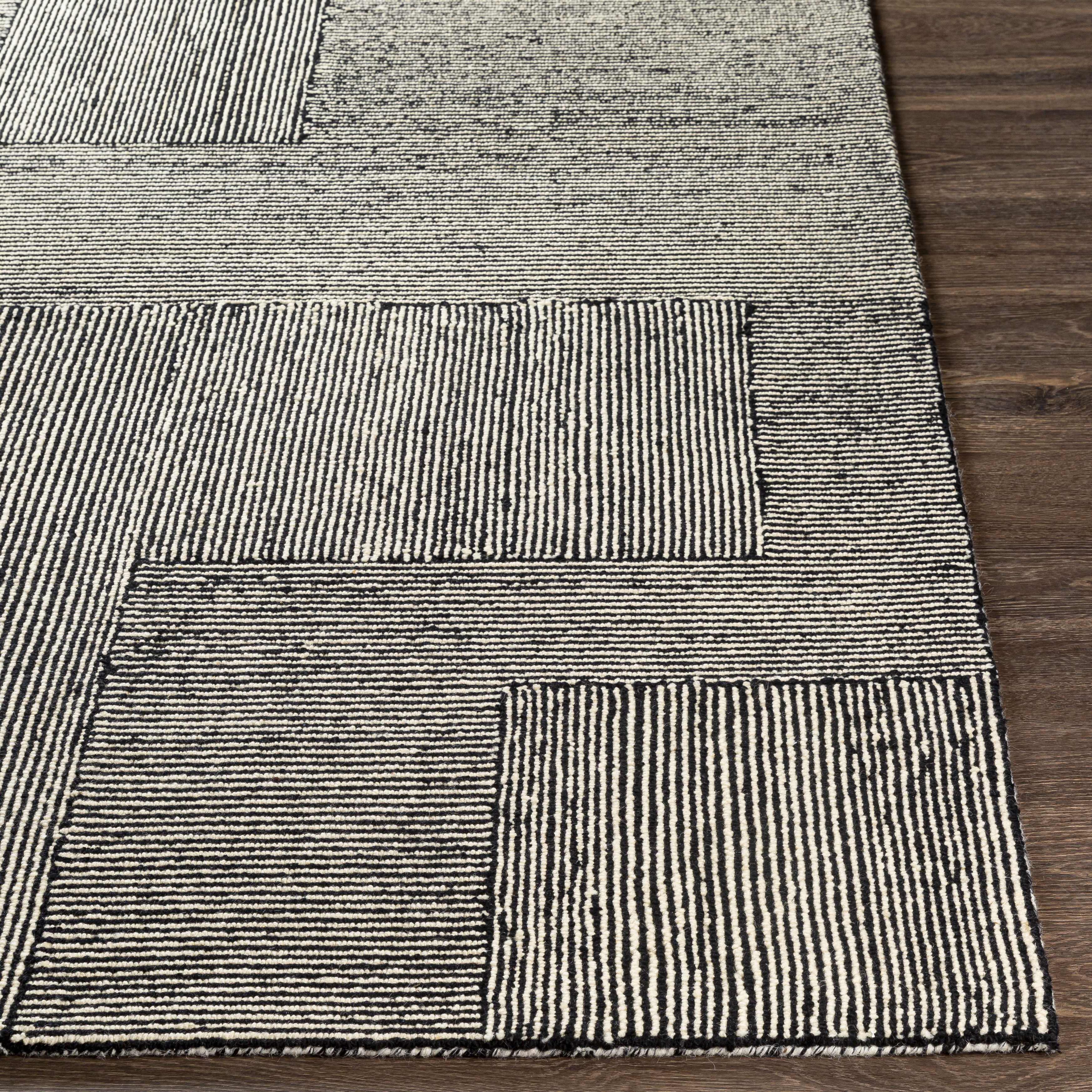 Textured rug with geometric pattern on a wooden floor