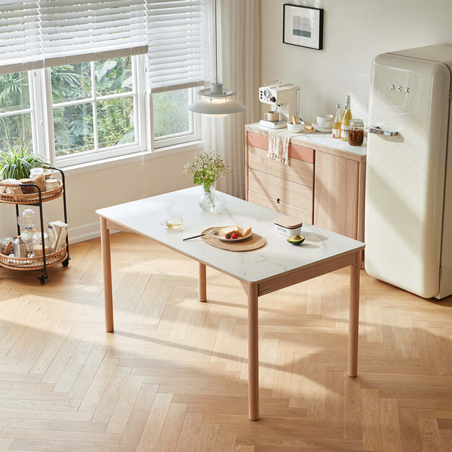 Modern kitchen with a marble table, refrigerator, and window view