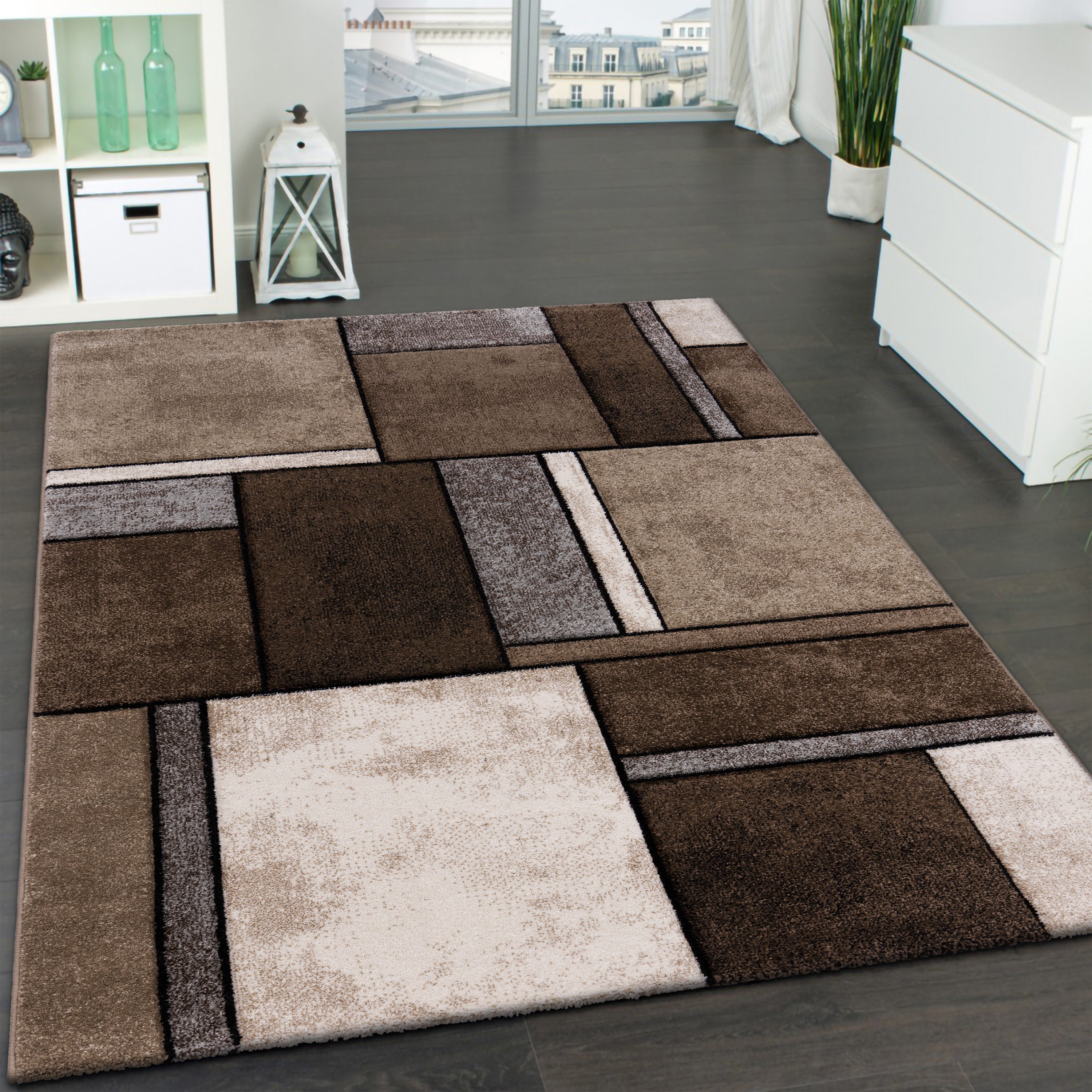 Patterned area rug on a gray floor with a modern interior setting.