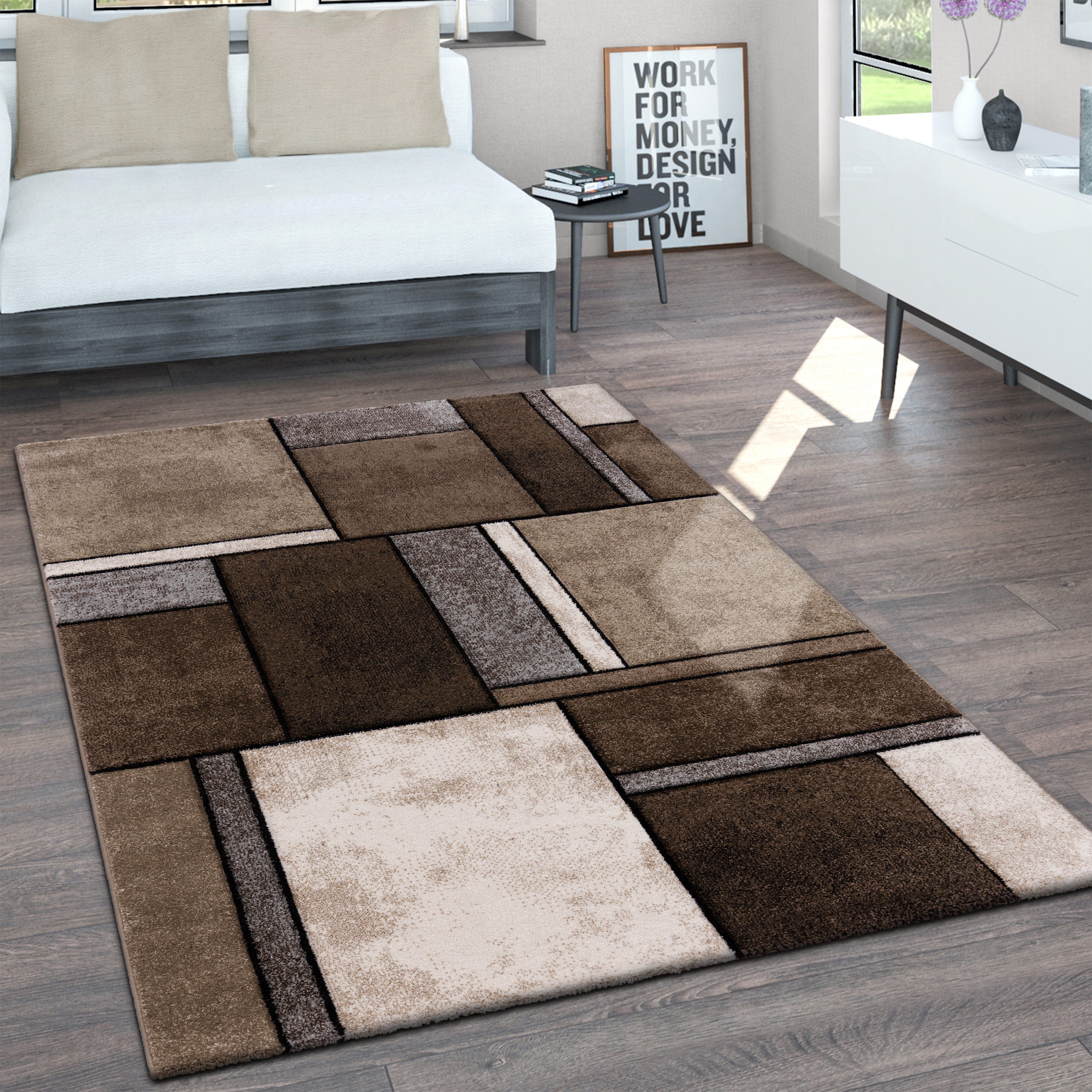Rectangular area rug with brown and beige square pattern on a wooden floor.